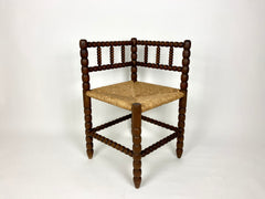 Antique oak bobbin turned corner chair with rush seat.